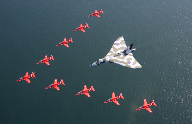A Vulvan B.2 flies with the RAF Red Arrows demonstration squadron during a ceremony marking the retirement of the Vulcan in 2015.